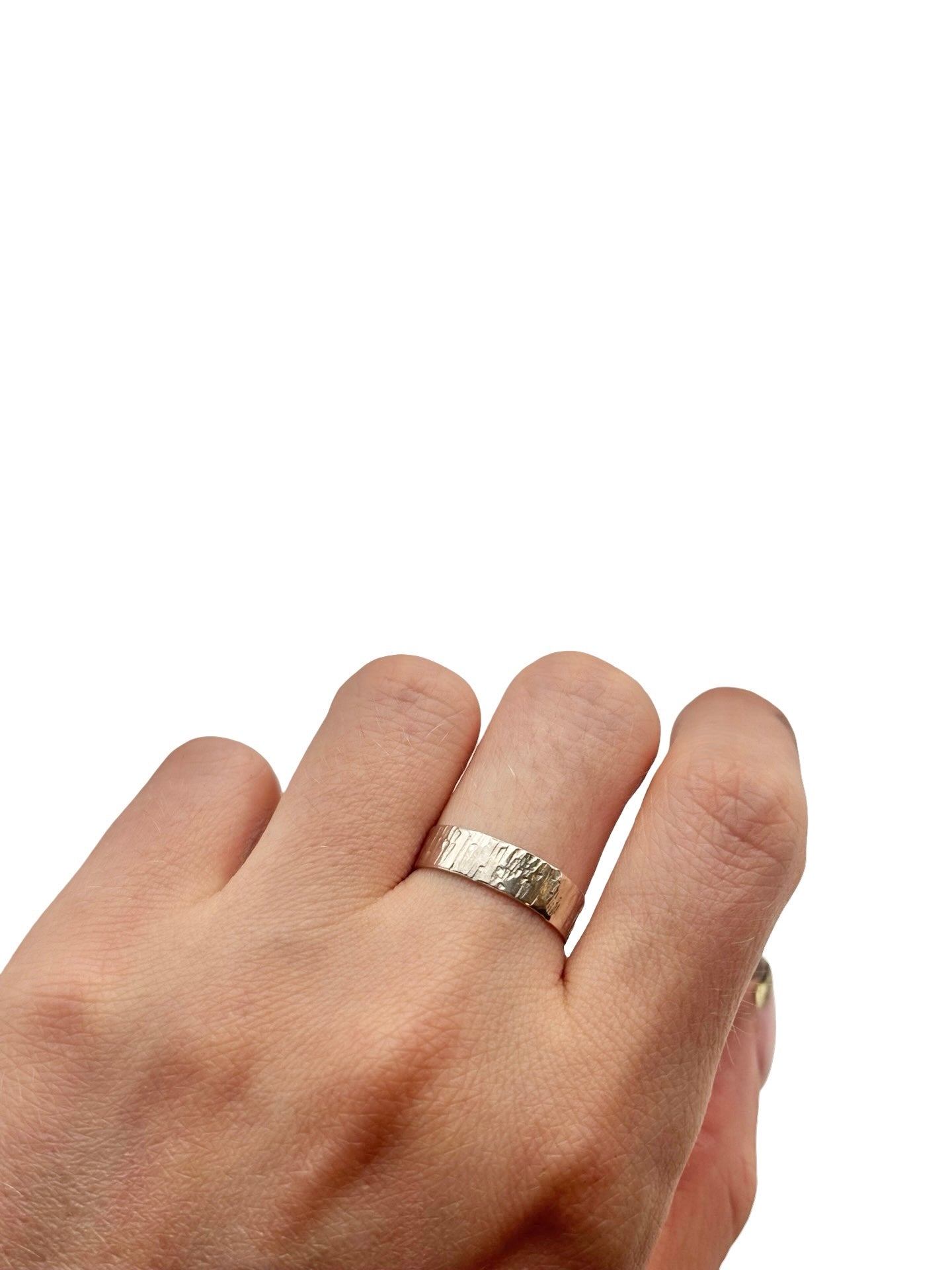 Hand wearing a silver  ring on a white background