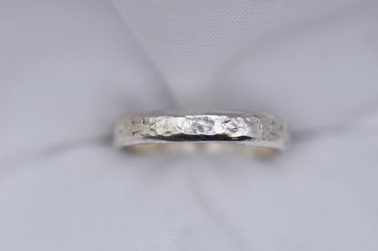Silver ring with texture light gray background