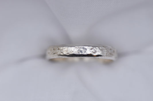 Silver ring with texture light gray background
